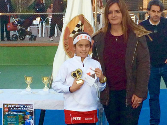 La presidenta del Club de Tenis 'Escudería Alba' entrega a PEKE el trofeo y cordaje como Campeona Infantil del 'I Open de Invierno' de Córdoba.